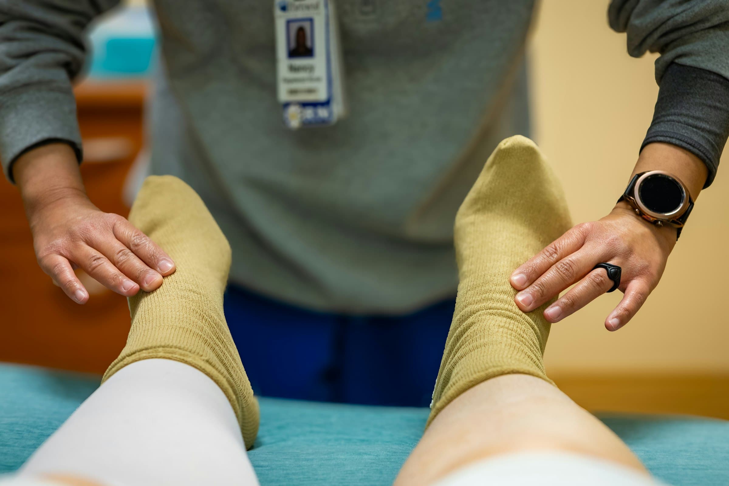A clinician checking circulation in a patient's foot