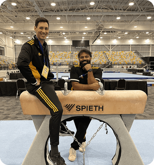 Angelo with a colleague at a gymnastics competition venue