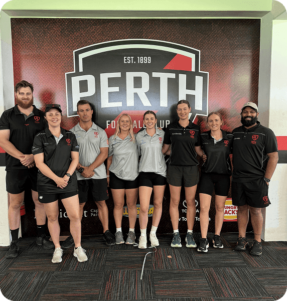 The Perth Football Club medical team, including Hypaforma's podiatrist, in front of the club crest