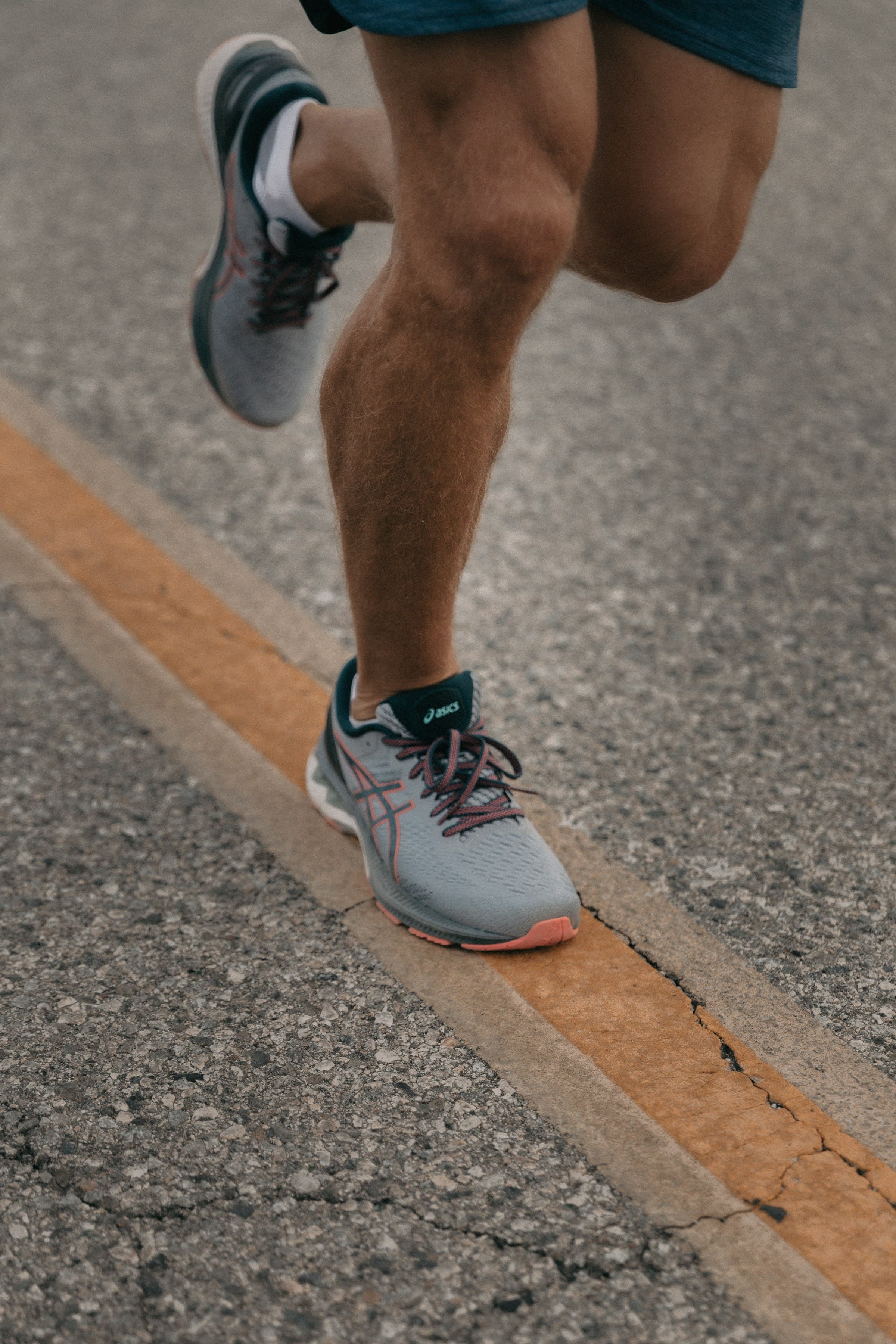 A runner's shoes photographed on the road
