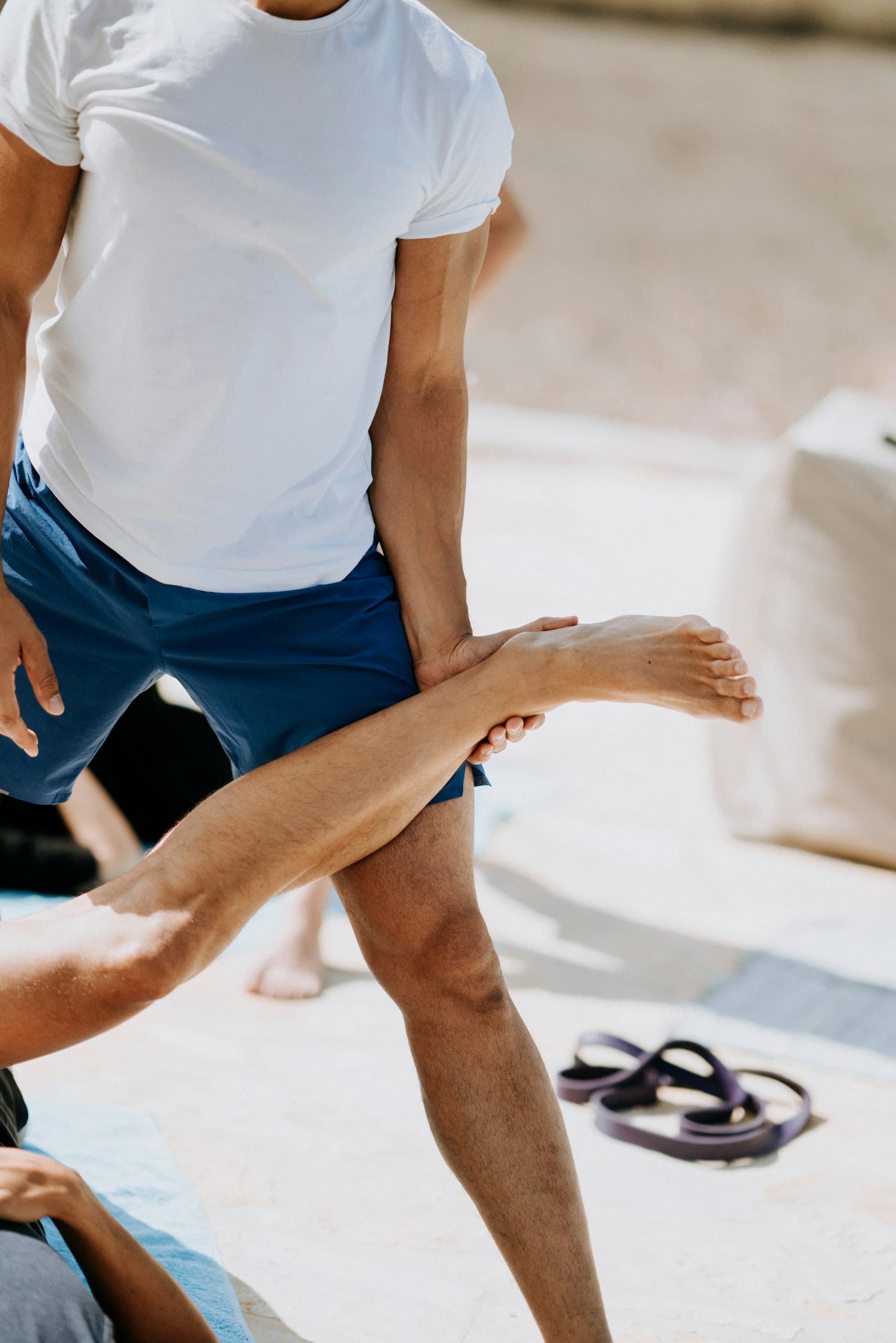 An athlete performing a stretching and conditioning exercise