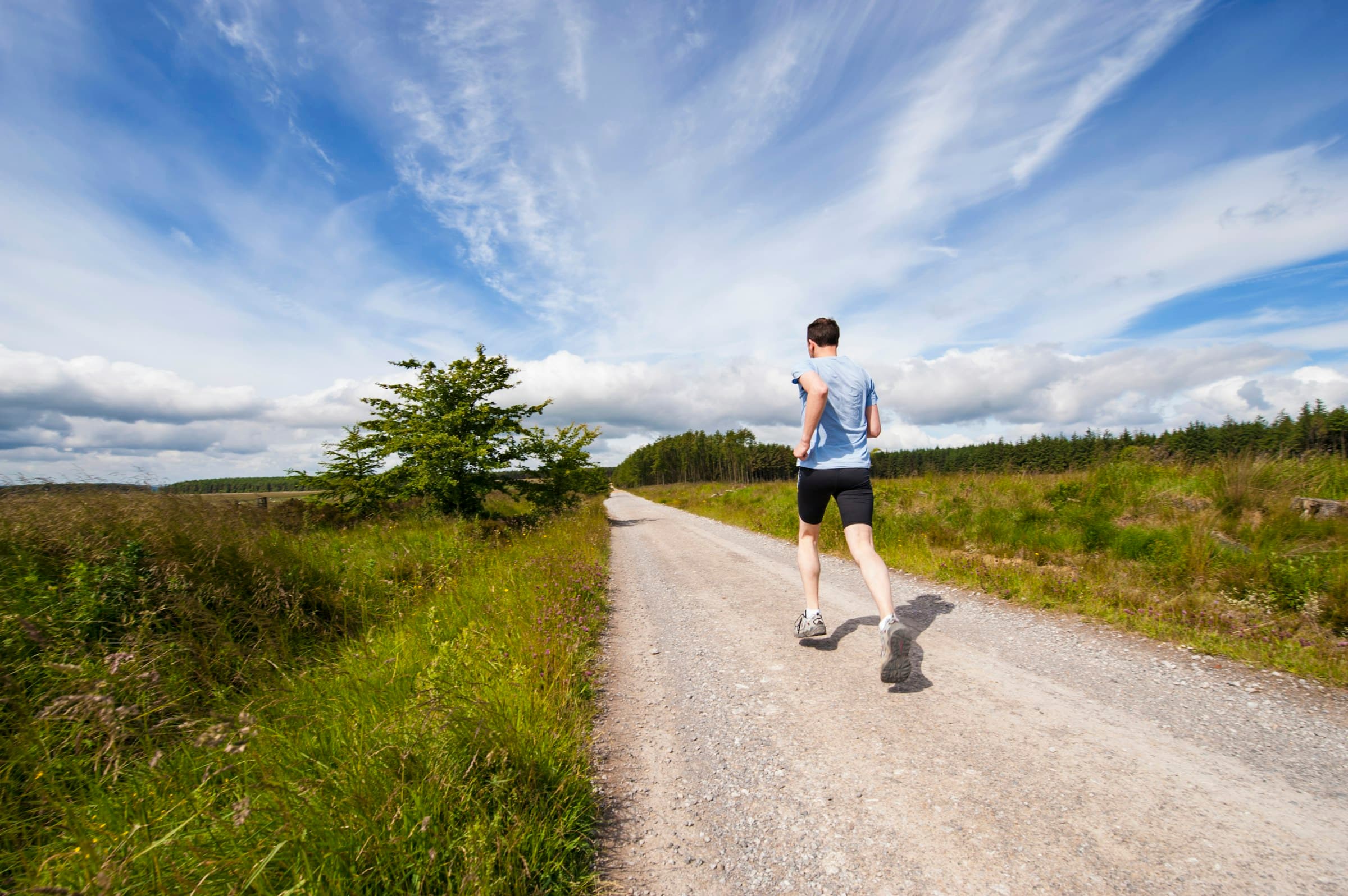 A trail runner on a rough track
